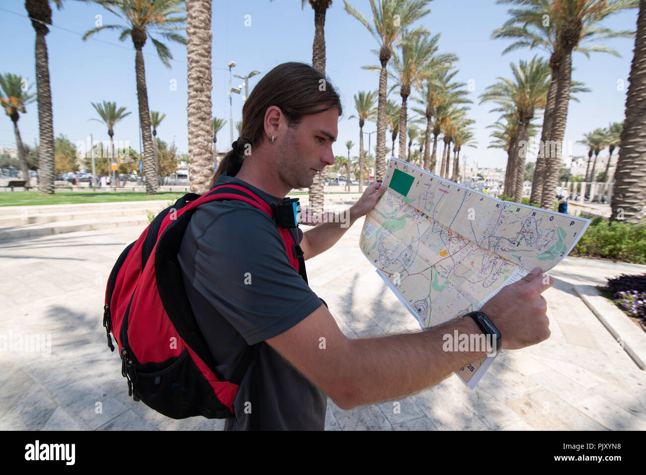 Close portrait of man looking on map in Jerusalem Stock Photo