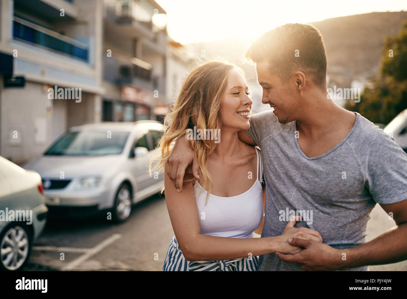 Affectionate Young Couple Holding Hands And Walking Arm In Arm Together Along A Street In The City At Sunset Stock Photo Alamy Affectionate Young Couple Holding Hands And Walking Arm In Arm Together Along A Street In The City At Sunset Stock Photo Alamy