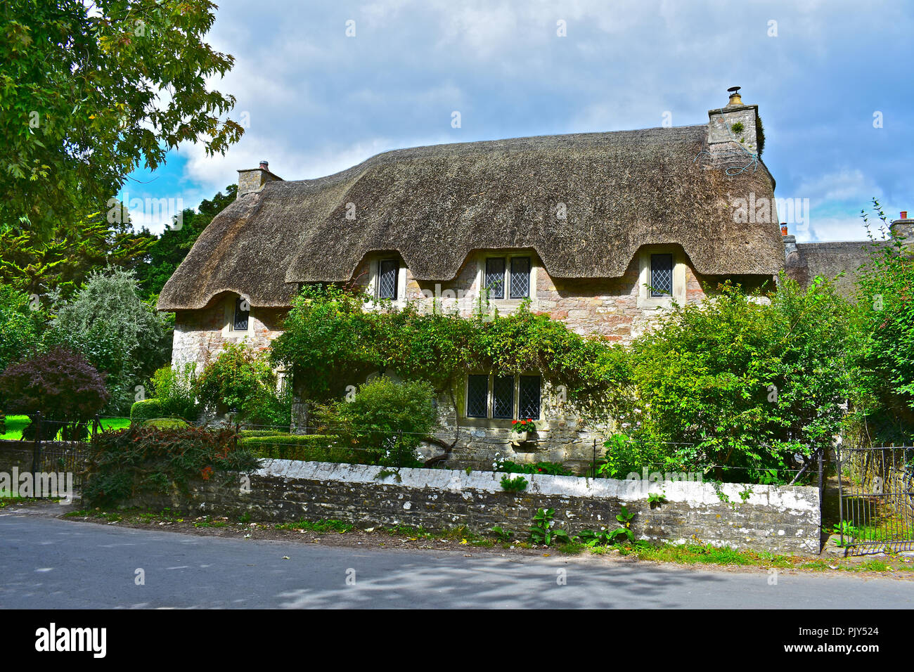 The pretty thatched roof house known as Church Cottage, in the small