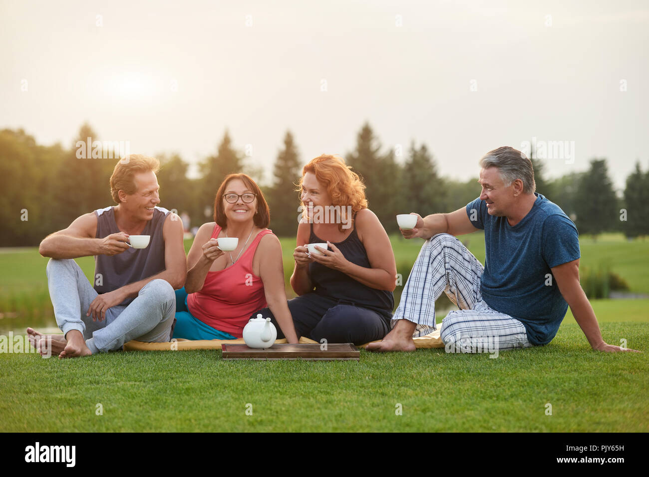 Two mature couples drinking coffee. Stock Photo