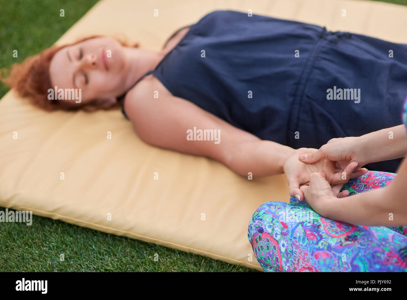 Thai hand massage in the park Stock Photo Alamy