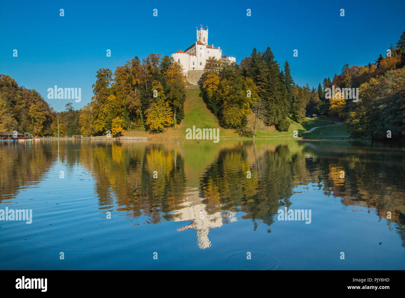 Castle of Trakoscan on the hill in autumn, Zagorje, Croatia, reflection on the lake Stock Photo