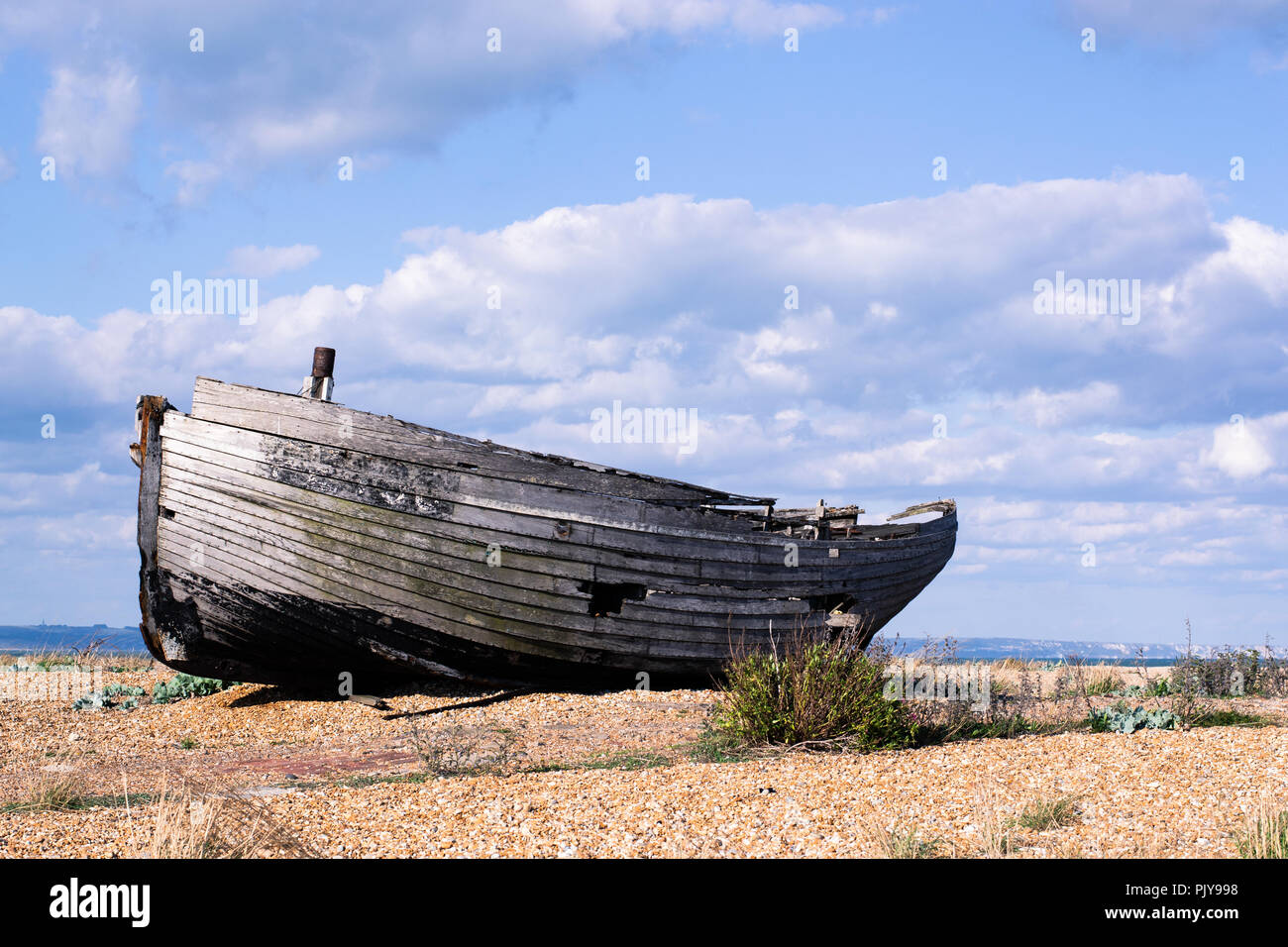 Boatwreck on a shingle beach Stock Photo