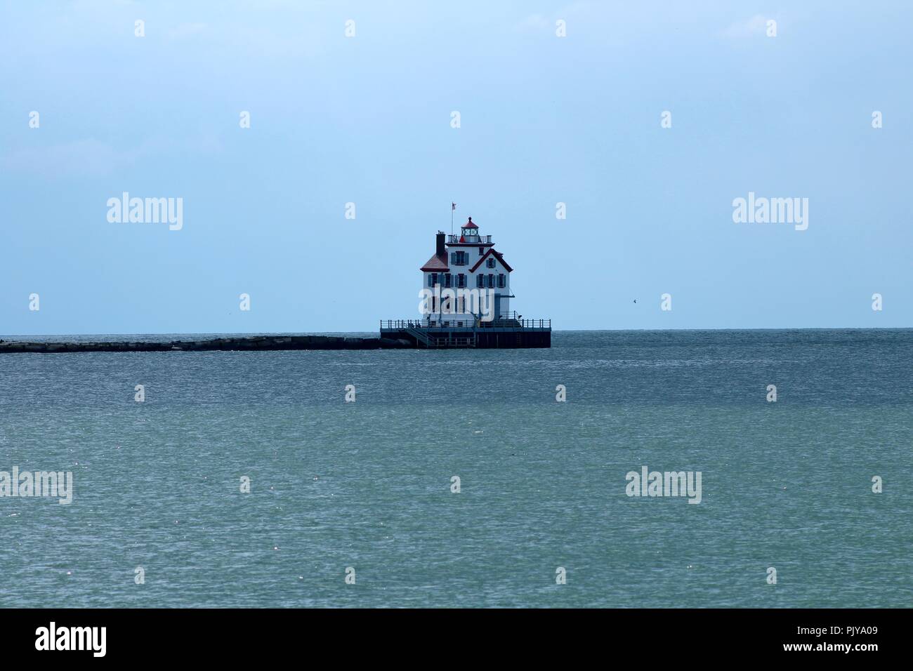 single lighthouse on the lake bright sunny day Stock Photo