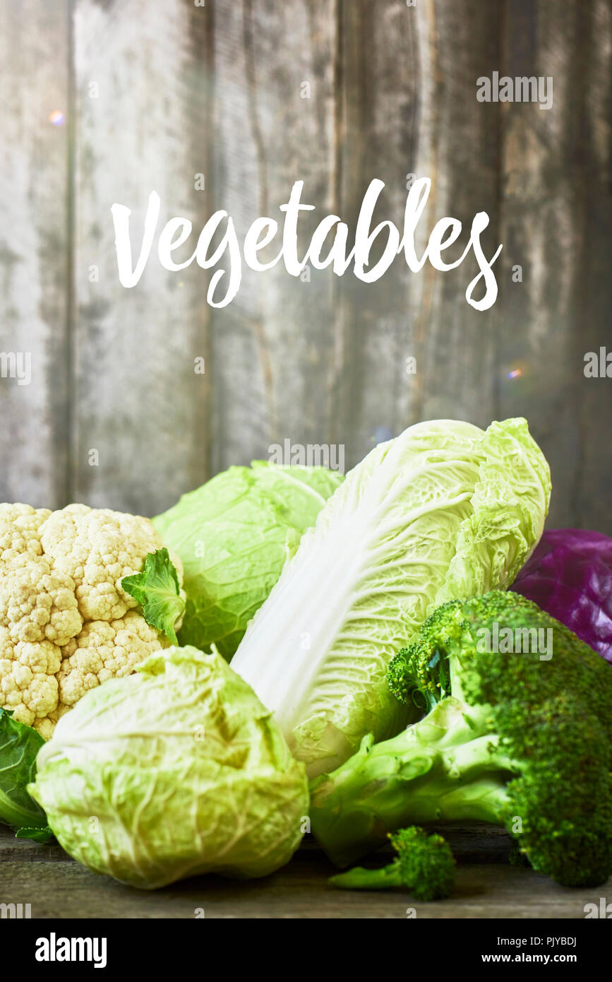 Many sorts of cabbage on rustic wooden background Stock Photo