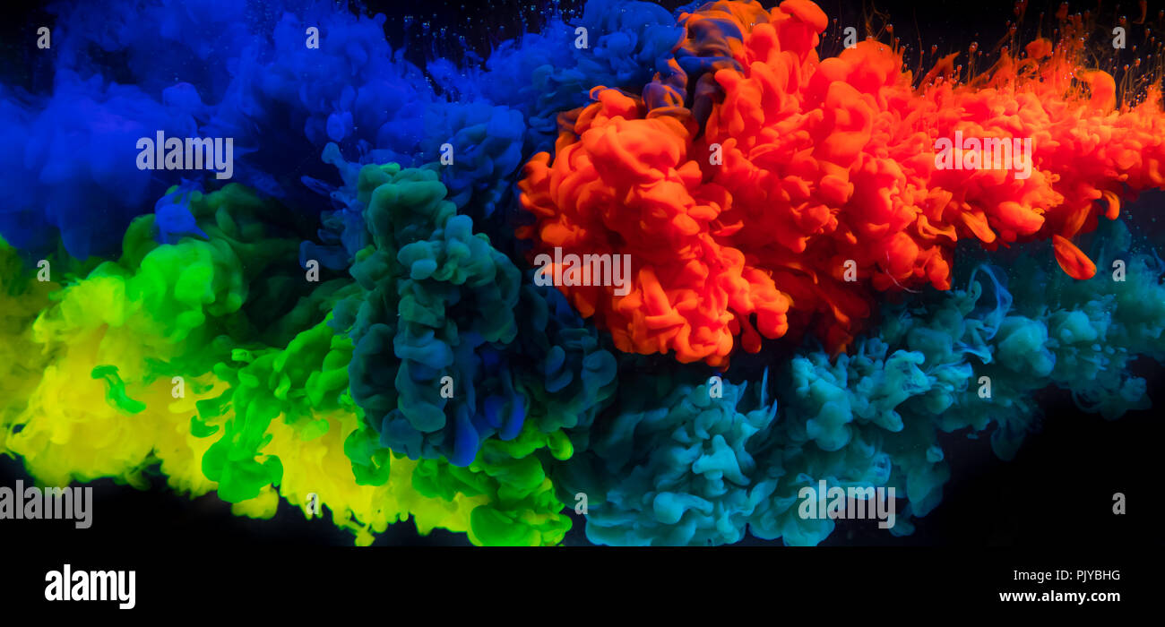 Mix of coloured inks in water on black background. Abstract colored background Stock Photo
