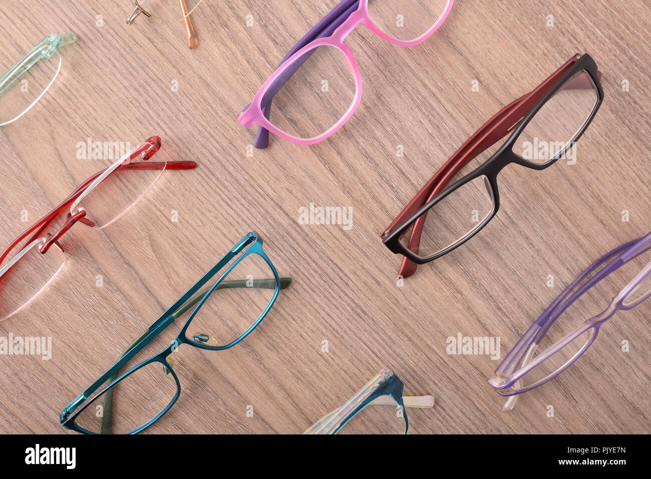 Stand of eyeglasses on wooden table in a eyewear store. Top view. Horizontal composition Stock Photo