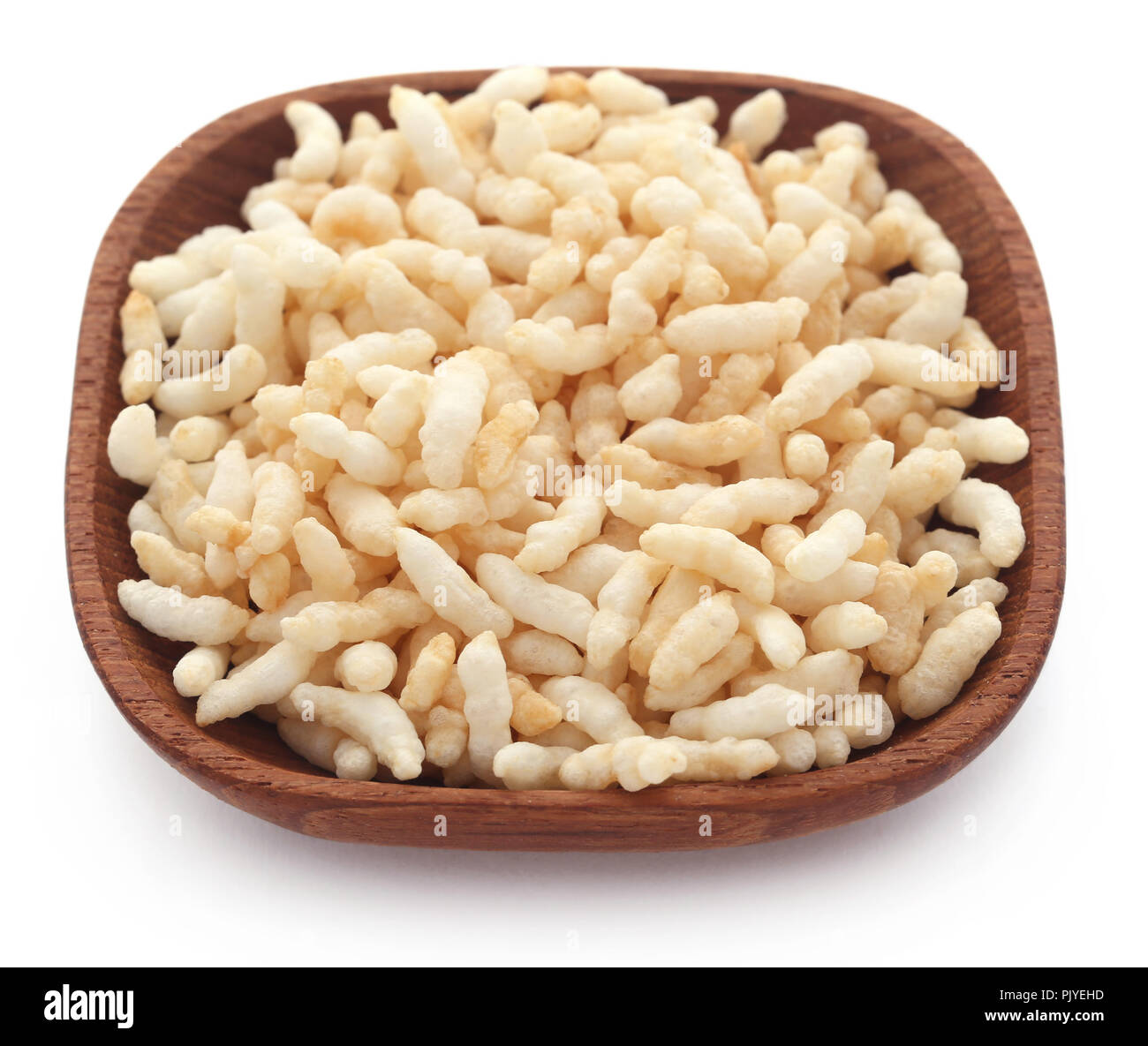 Puffed rice in a bowl over white background Stock Photo