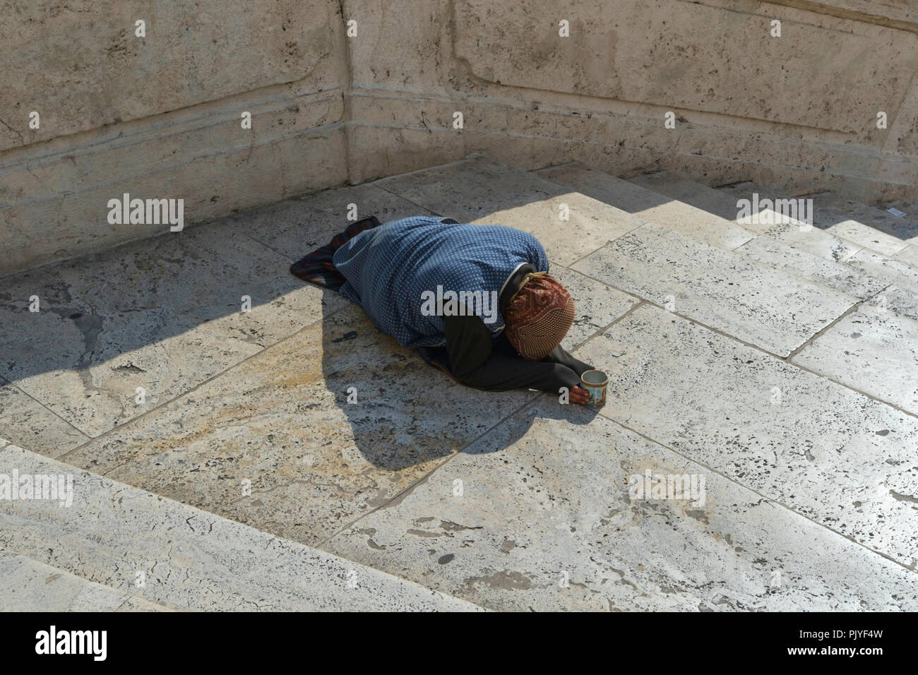 Female beggar with a cup on the Spanish Steps in Rome, Italy, Europe. Stock Photo