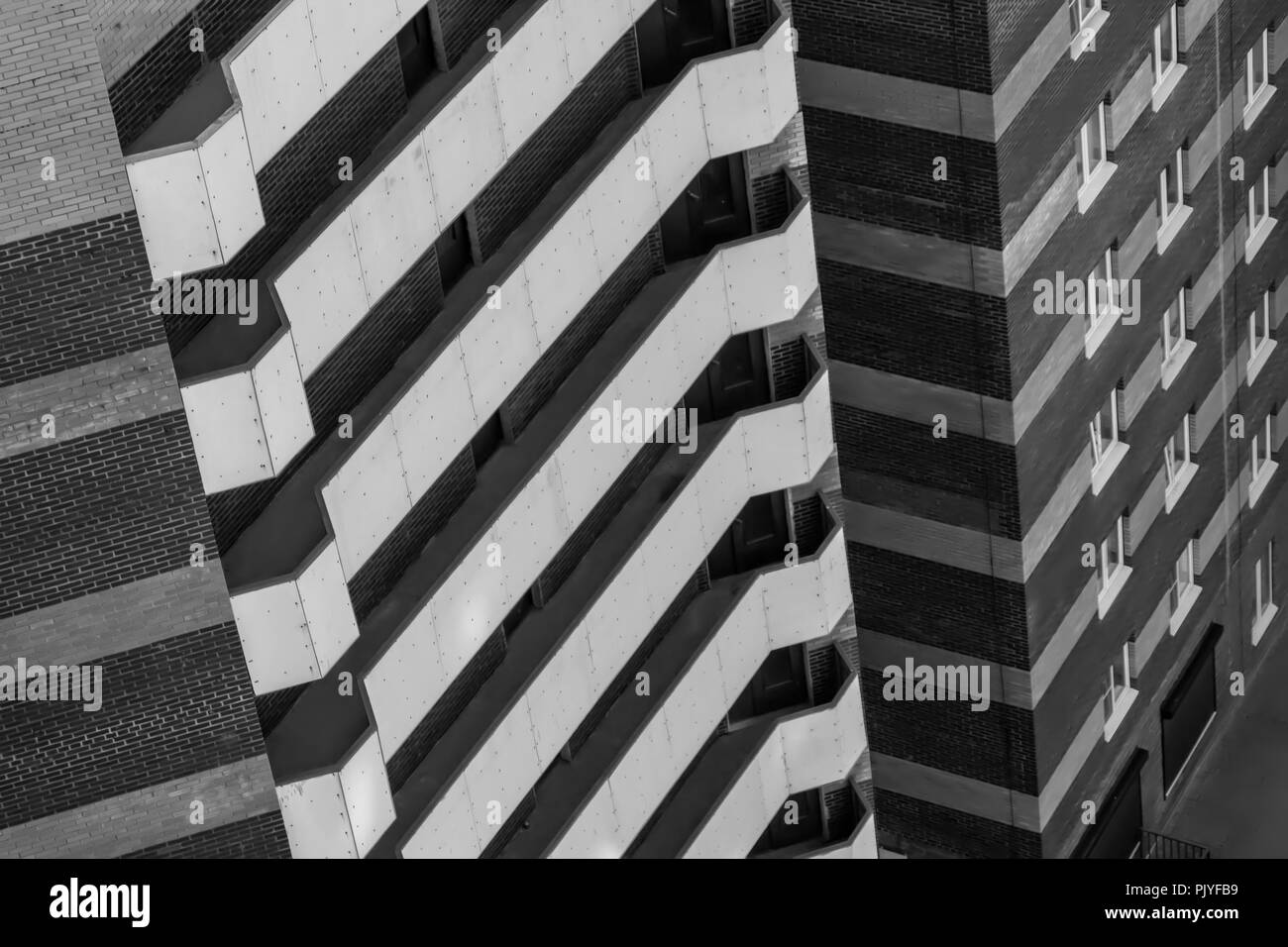 White balconies on a brick building, black and white Stock Photo - Alamy