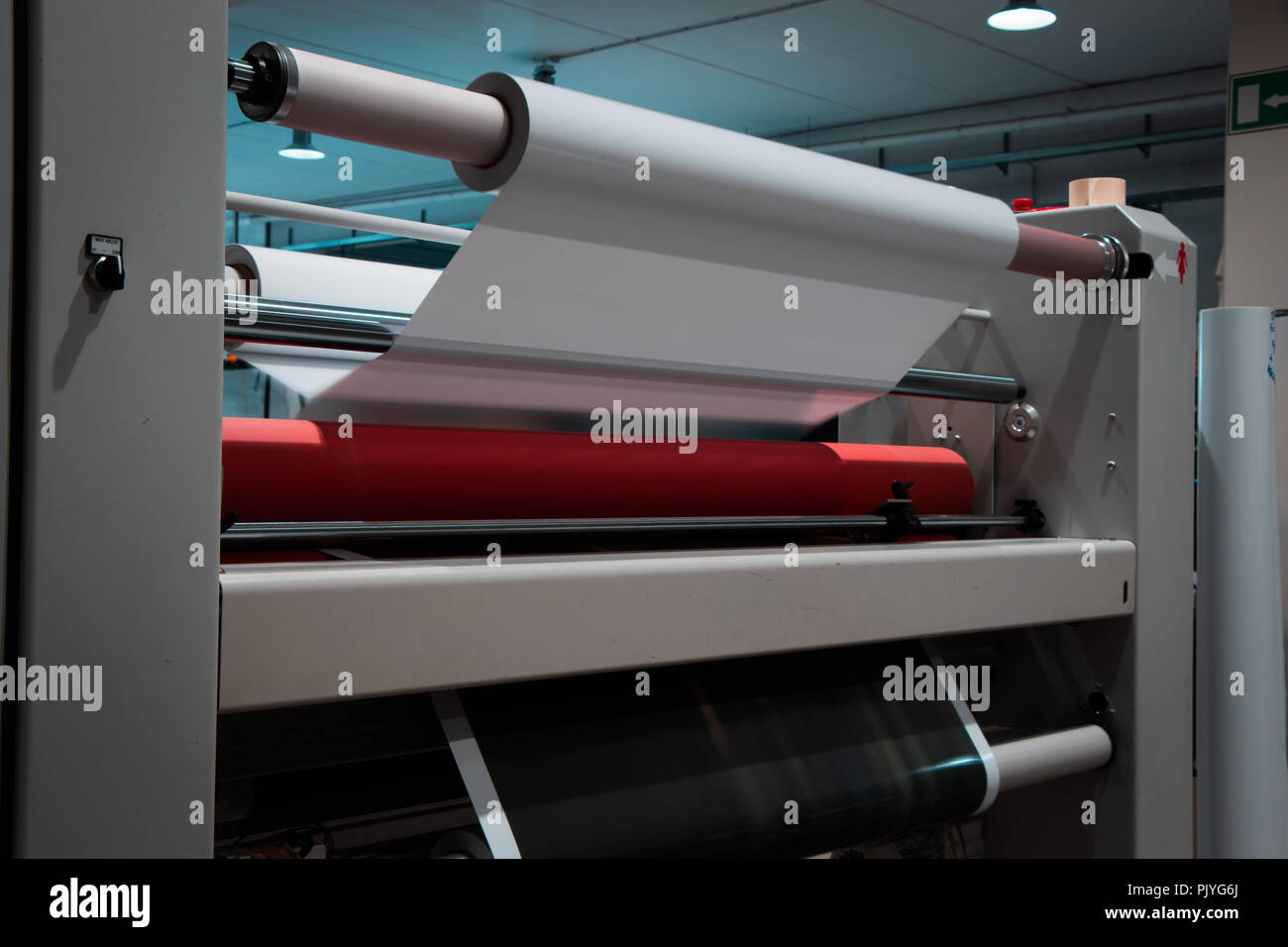 Big professional printing laminator, armed with large red rolls of