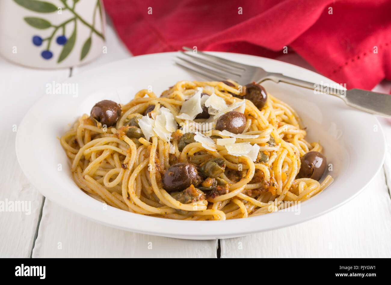 Pasta with black olives and anchovies on rustic white table Stock Photo Alamy