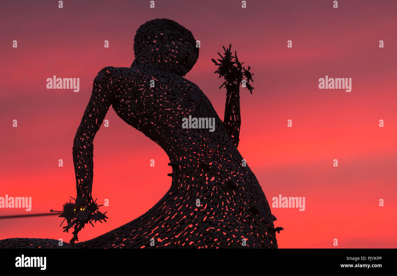 Uttoxeter, UK. 9 September 2018. The sun sets behind the Centaur Sculpture in Uttoxeter, Staffordshire, UK. It was designed by Andy Scott and is one of two sculptures on roundabouts on the A518 road. 9th September 2018. Credit: Richard Holmes/Alamy Live News Stock Photo