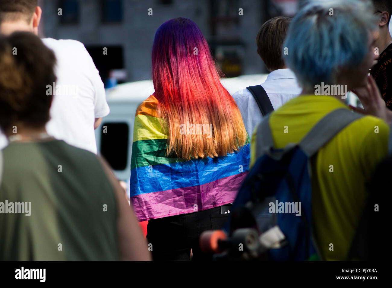 Moscow, Russia. 9th Sept 2018. A young woman with dyed hair is showing her support for the LGBT movement by wearing a rainbow-coloured flag during an anti-government rally in Moscow where Russian opposition activists gathered to express resentment about an upcoming pension refrom. Credit: Roman Chukanov/Alamy Live News Stock Photo