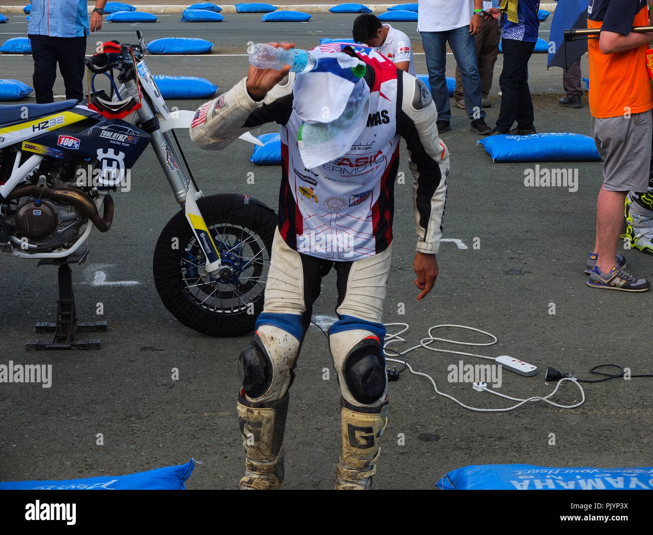 Manila, Philippines. 20th Feb, 2013. A rider from Malaysia seen dousing ...