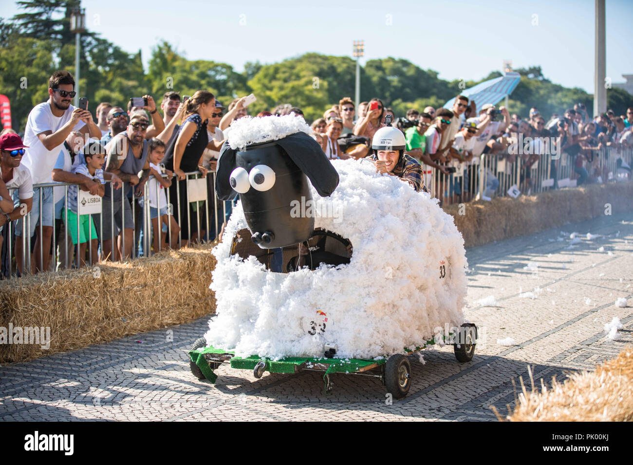 Lisbon, Portugal. 9th Sep, 2018. The car ''Fuga das Ovelhas'' encourages the spectators when passing through the ''jump of the Marquess'' at the 3rd Grand Prix Red Bull in Lisbon known as ''The Crazy Race in the World''.''The Crazy Race in the World'' is an event for amateur riders racing on handmade cars. The vehicles move by creativity and friendly competition, without ever forgetting the speed adrenaline. This race of vehicles without motor, proposes to the participants the construction of a car that defies the norms of the design and the laws of the physics. They will compete agains Stock Photo