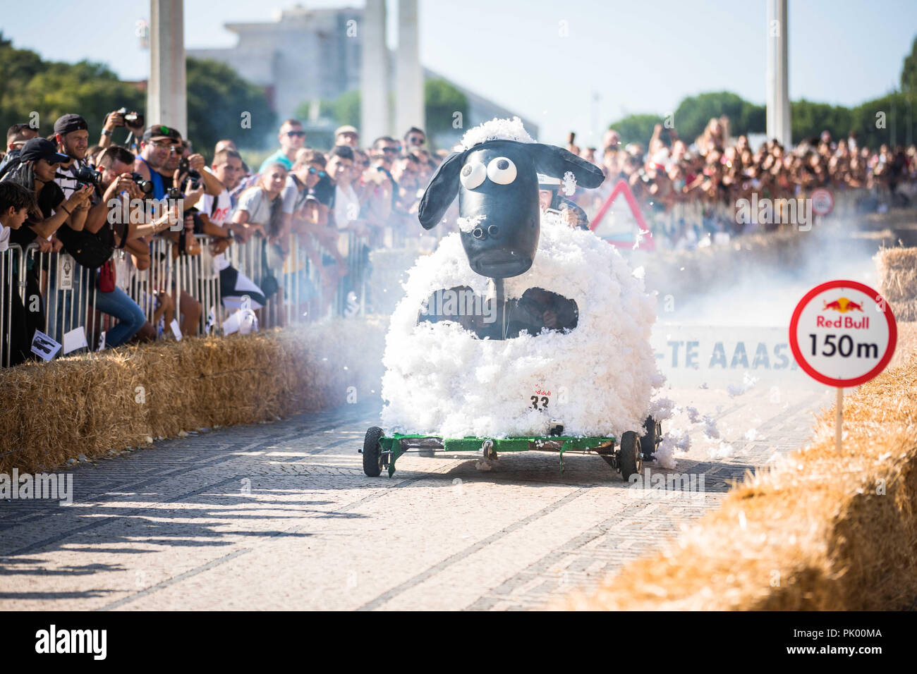 Lisbon, Portugal. 9th Sep, 2018. The car ''Fuga das Ovelhas'' encourages the spectators when passing through the ''jump of the Marquess'' at the 3rd Grand Prix Red Bull in Lisbon known as ''The Crazy Race in the World''.''The Crazy Race in the World'' is an event for amateur riders racing on handmade cars. The vehicles move by creativity and friendly competition, without ever forgetting the speed adrenaline. This race of vehicles without motor, proposes to the participants the construction of a car that defies the norms of the design and the laws of the physics. They will compete agains Stock Photo