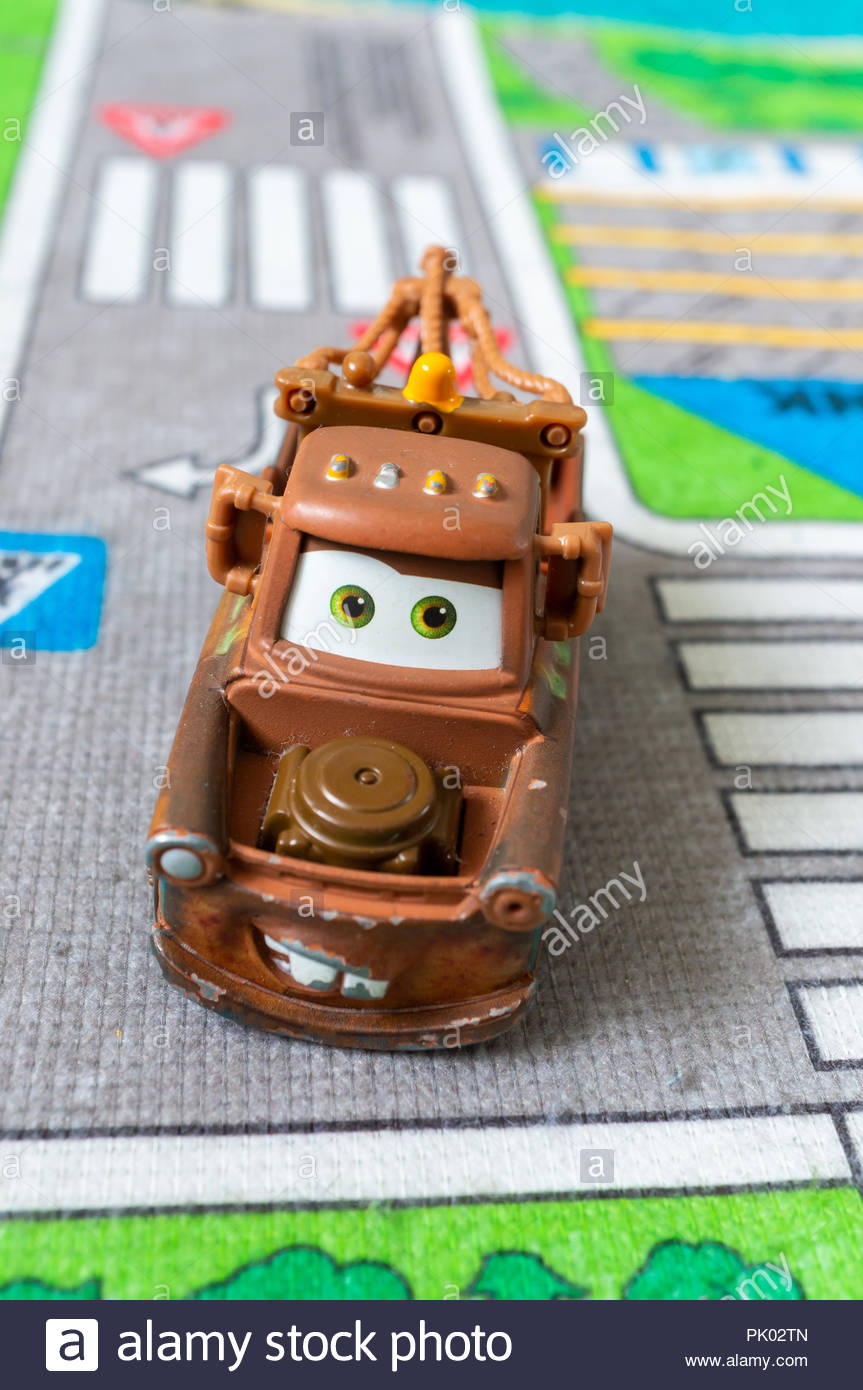 Mattel Disney Pixar toy Tow Mater on a play mat. Staged simulation of a