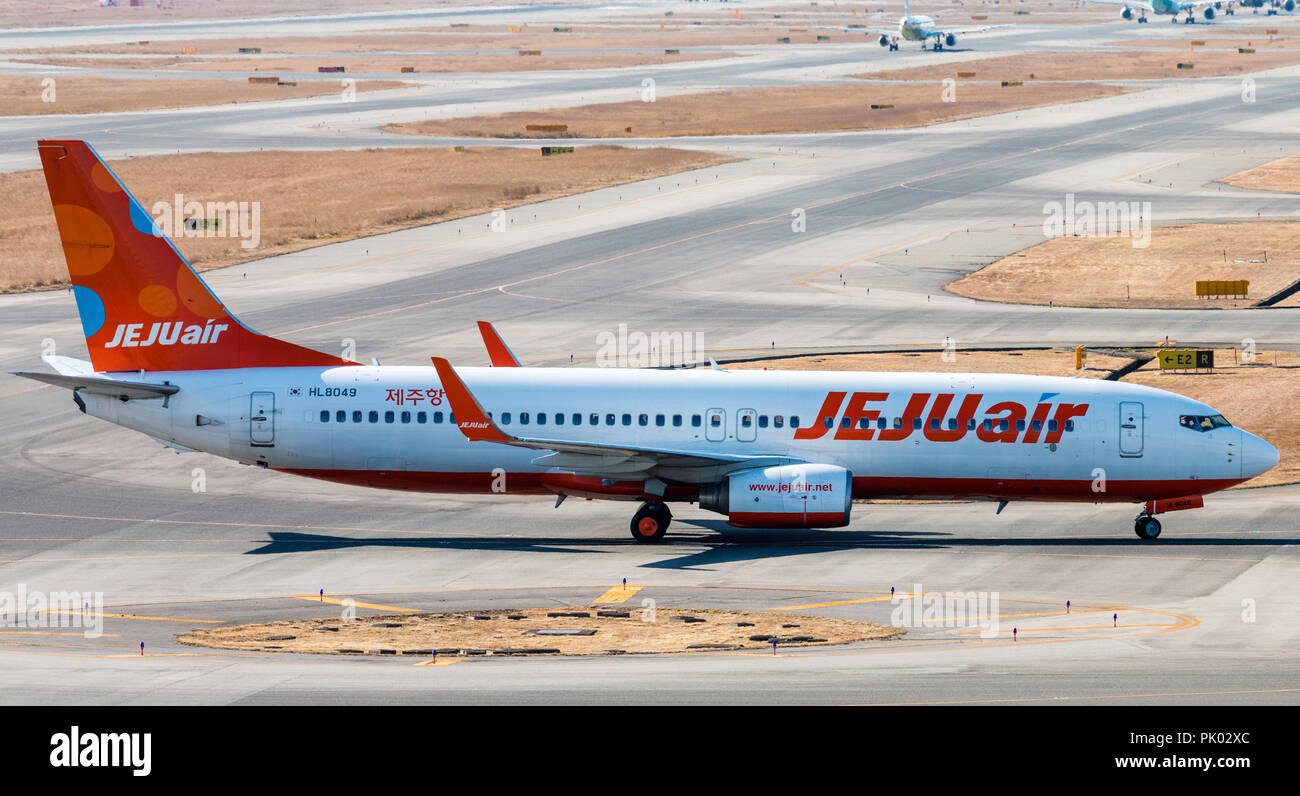 Japan, Osaka. Kansai International Airport. KIX. Passenger jet Boeing 737, HL 8049 JEJU airlines, taxiing along taxiway to terminal building after lan Stock Photo