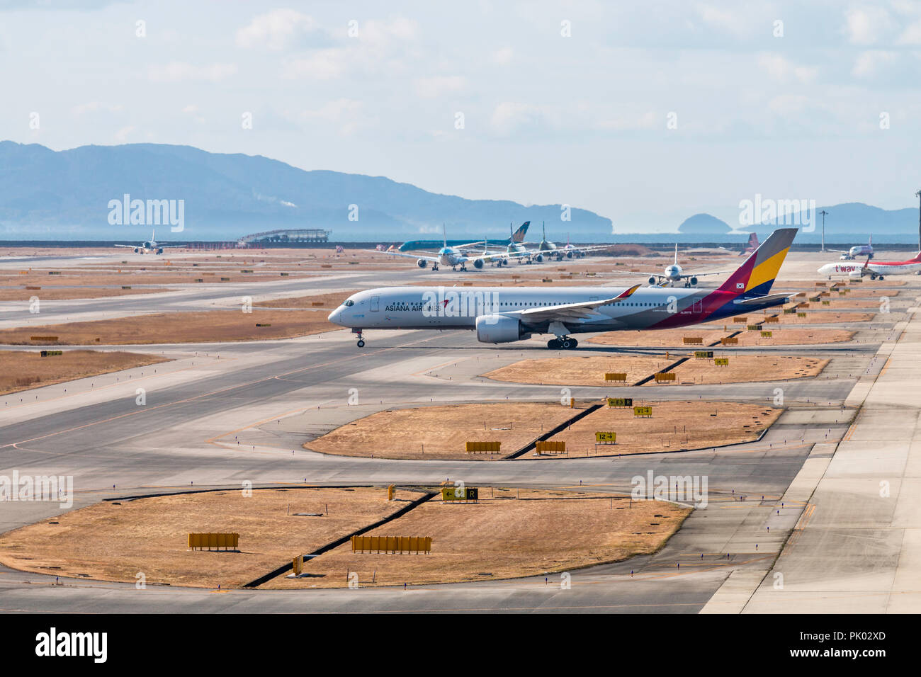 Japan, Osaka. Kansai International Airport. KIX, Passenger jet, Airbus 350 Asiana airlines, taxiing along taxiway before taking off. Stock Photo