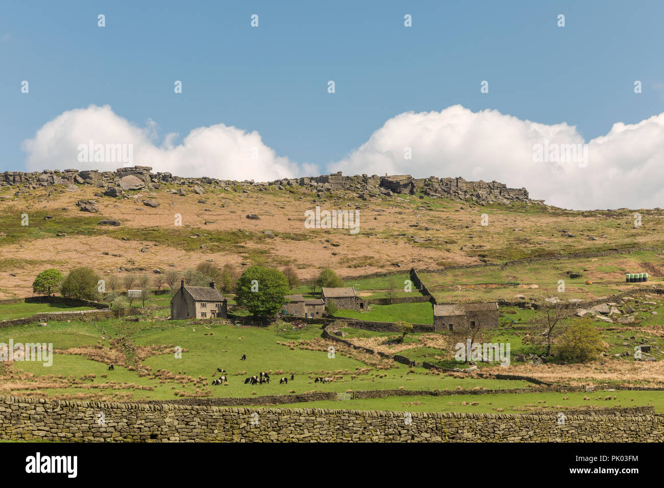 An ancient farmyard situated on moorland looking towards Stanage Edge, Derbyshire, England, UK Stock Photo