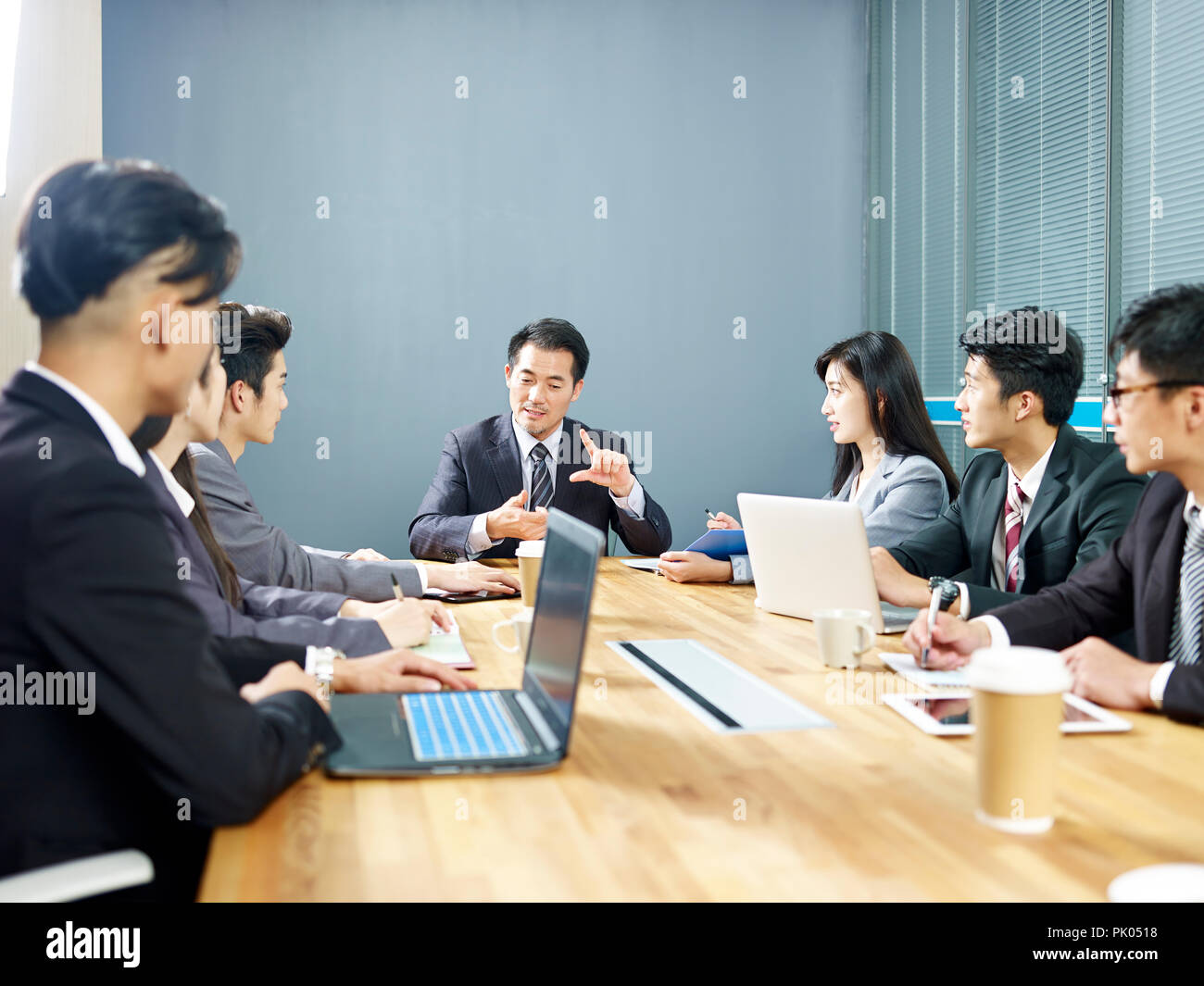 team of asian corporate business people men and women meeting in office. Stock Photo