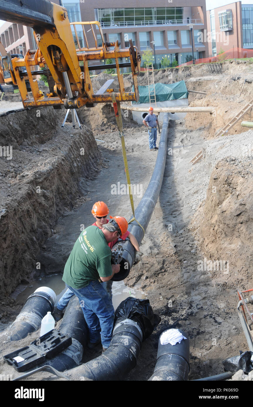 Laying pipe on a commercial construction site Stock Photo Alamy