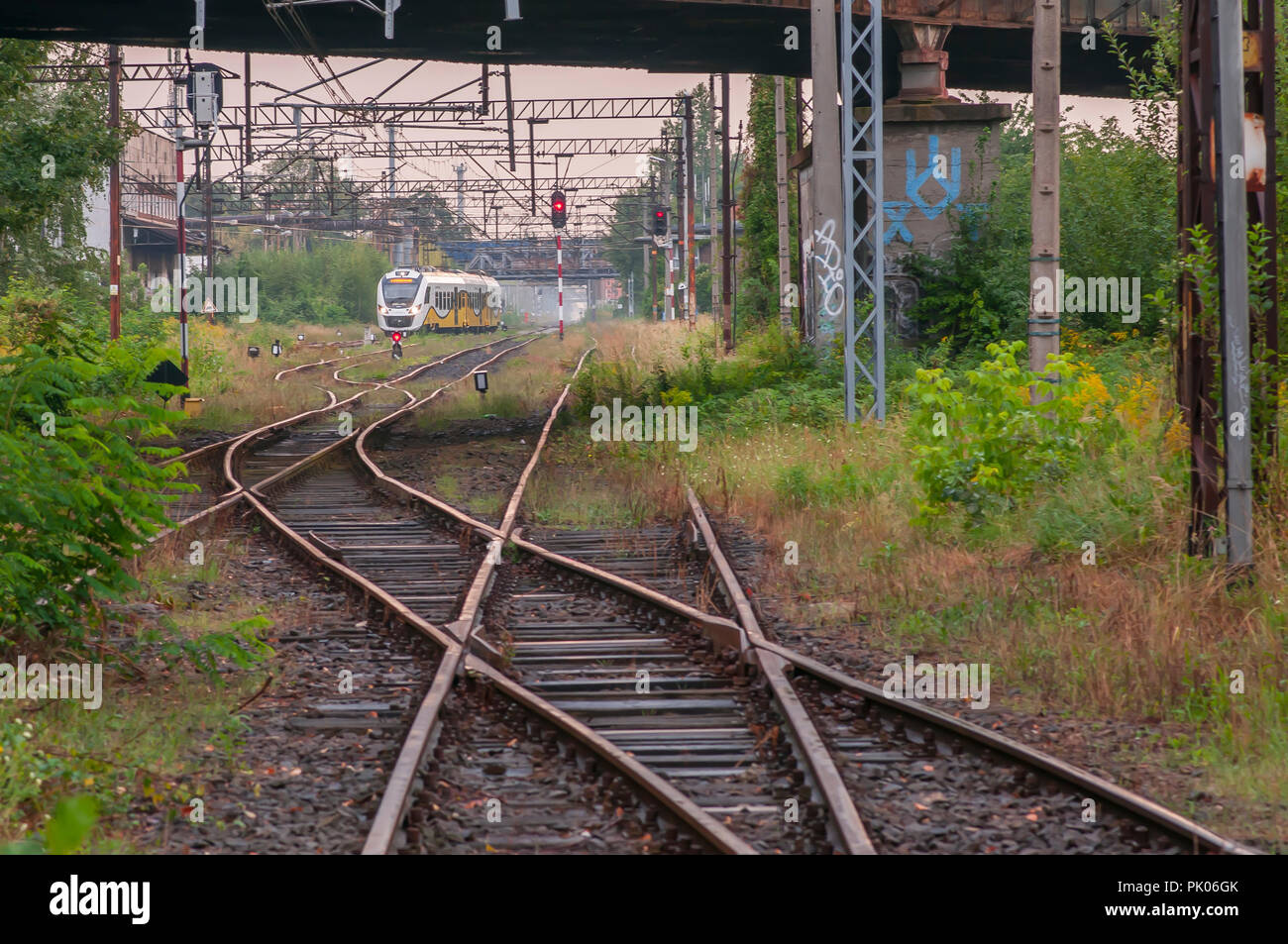 The separation of old railway line. Modern train in the back. Wroclaw ...