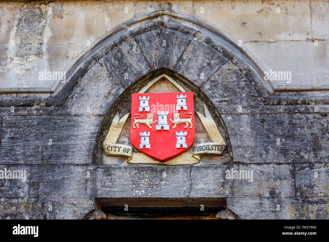 City of Winchester coat of arms with two lions passant guardant and five Castles triple towered on a wall in Winchester, Hampshire, southern England Stock Photo