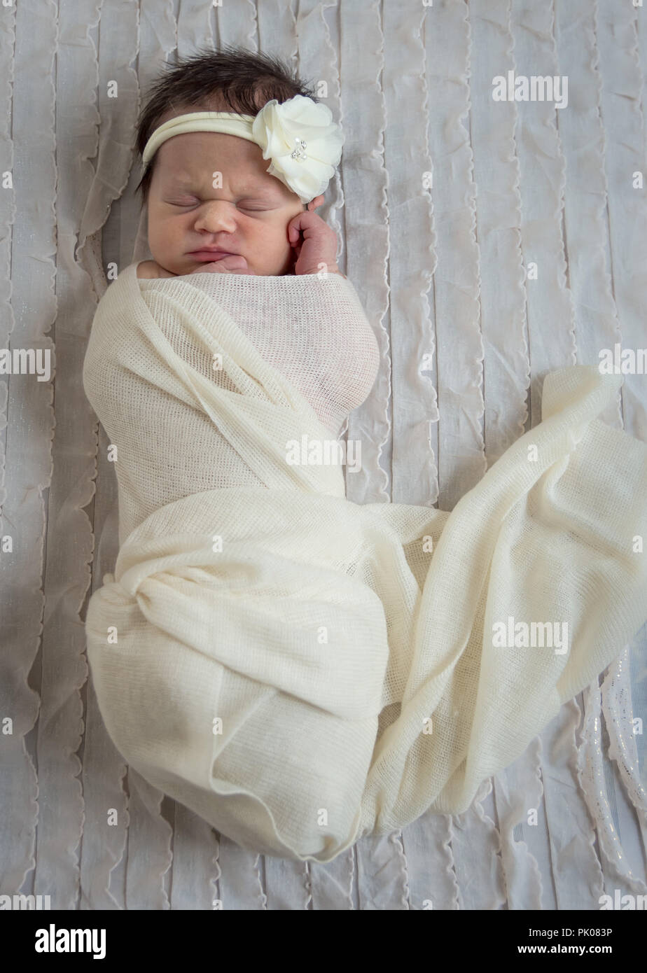 Newborn in White Wrap Stock Photo
