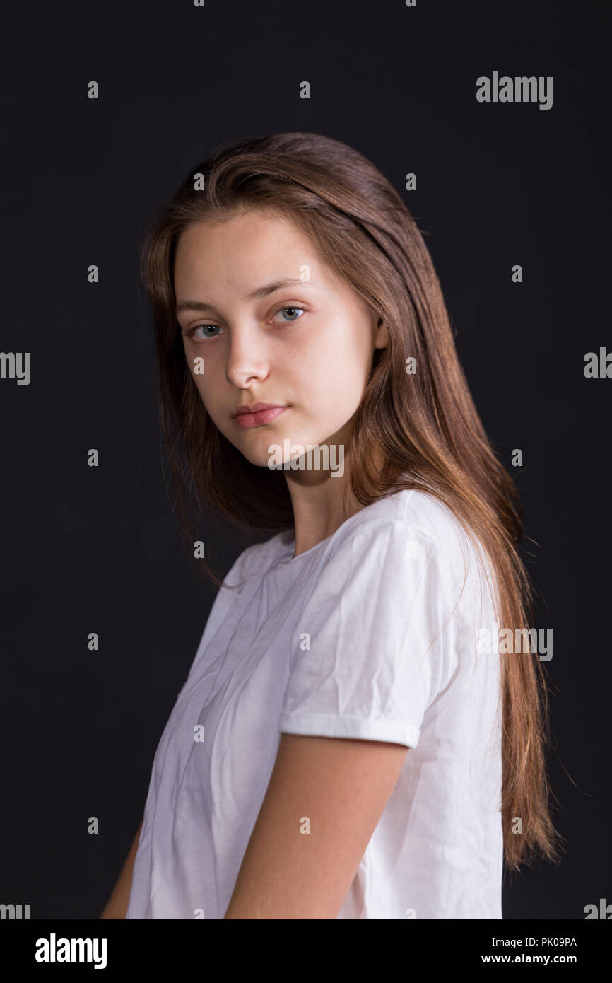 Close Up Of A Beautiful Girl With Brown Hair And Blue Eyes Iin White T Shirt Solated On A Dark Background Stock Photo Alamy