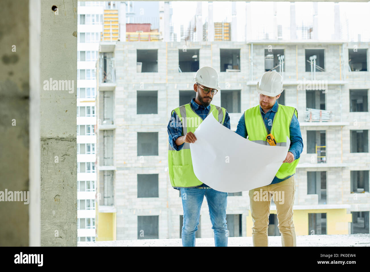 Serious construction designers viewing sketch Stock Photo