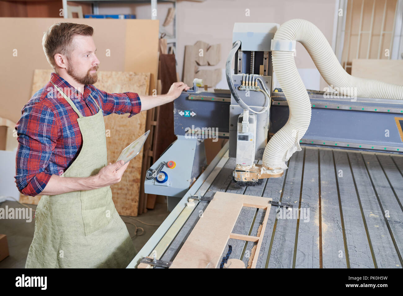 Carpenter at machine Stock Photo