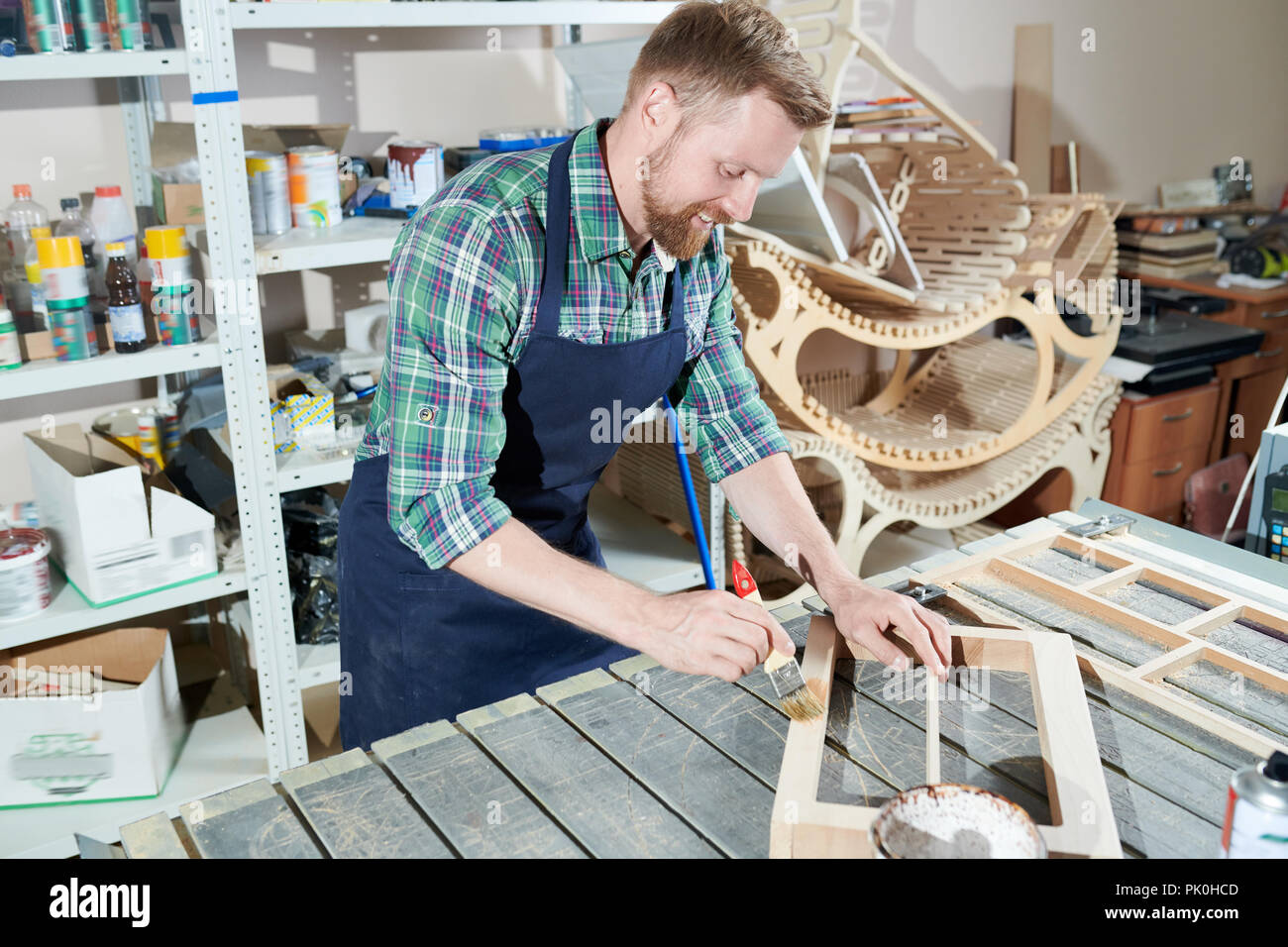 Carpenter painting wood Stock Photo Alamy