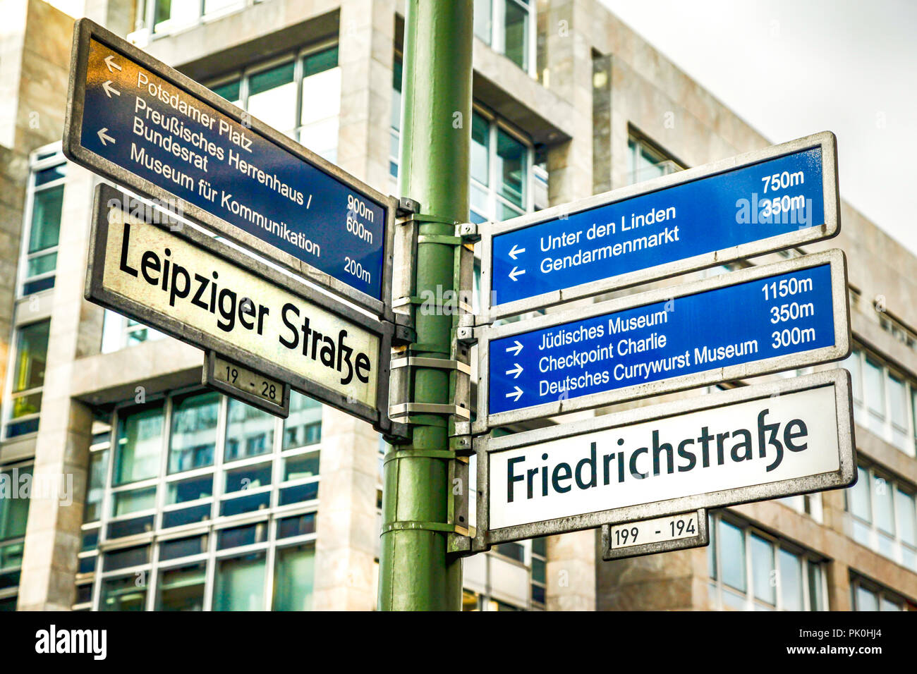Multiple destinations signpost on the corner of Friedrichstrasse and Leipziger Strasse in Berlin, Germany Stock Photo