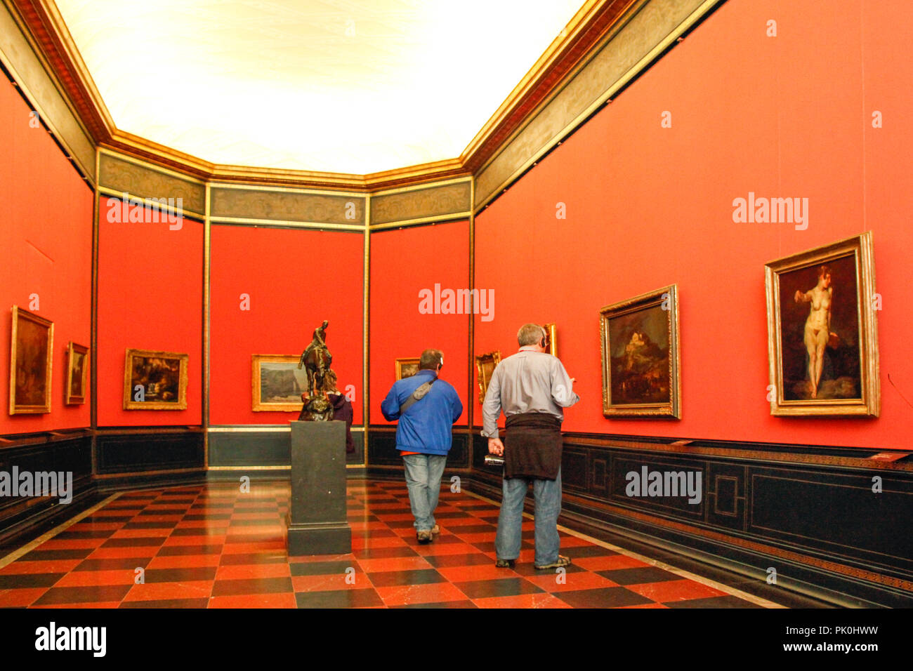An impressive red room gallery with paintings and people in the National  Gallery, Berlin, Germany Stock Photo - Alamy