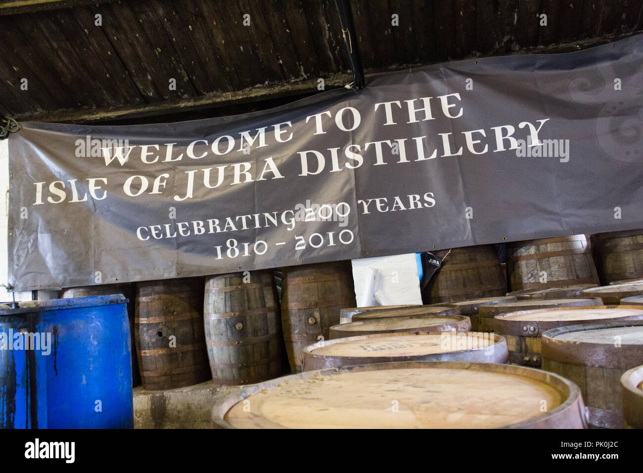 Welcome to the Isle of Jura Distillery sign and barrels, Craighouse, Jura, Scotland. Stock Photo