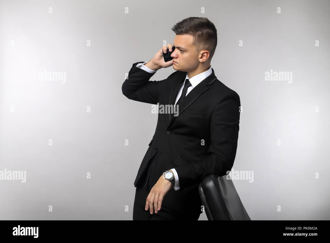Businessman talking on mobile phone in office Stock Photo