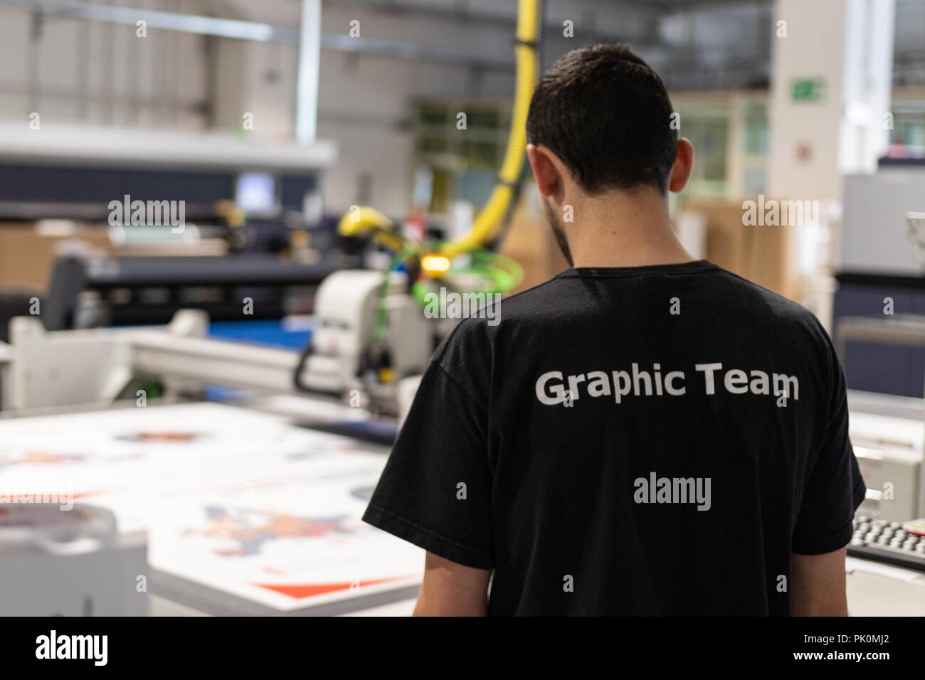 Production manager supervising every step of the project workflow, from paper supply and print setup, to quality control and packaging. Stock Photo
