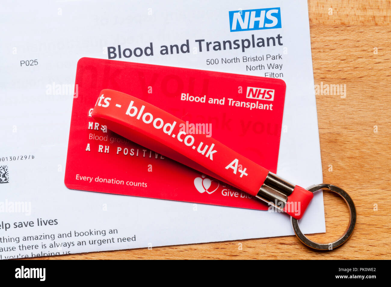 Blood donation card, letter & key ring showing blood group. Stock Photo