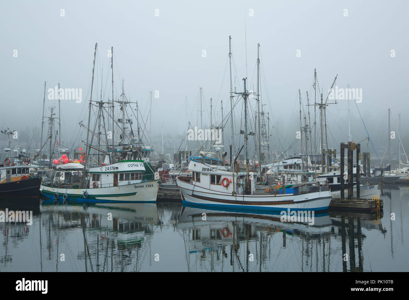 Boats in fog, Ucluelet Harbour, Ucluelet, British Columbia, Canada Stock Photo
