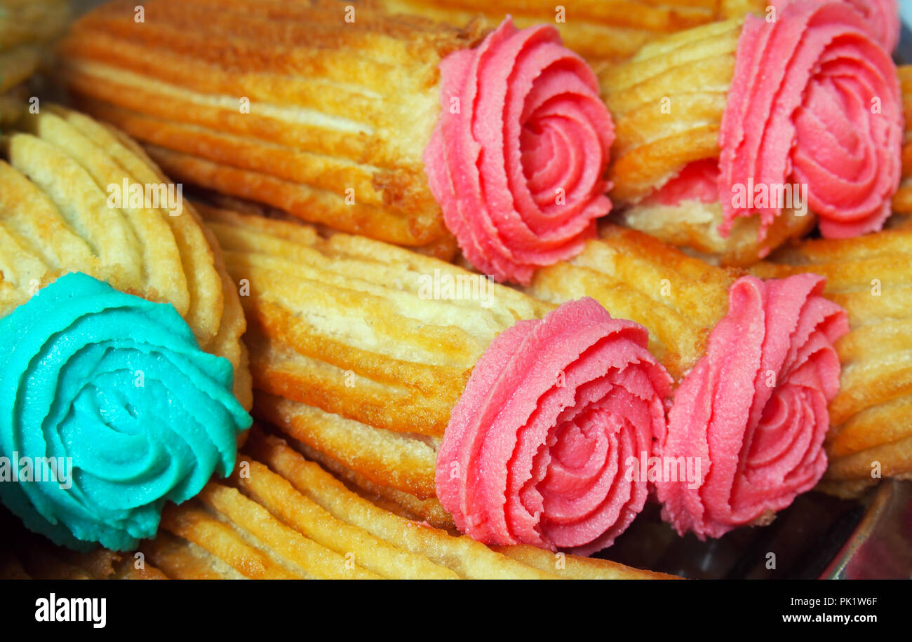 Spanish traditional frieddough pastry porras with colorful glaze tops