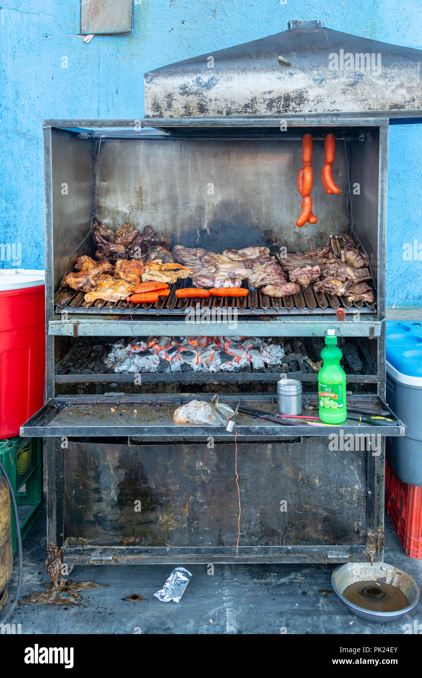 Meat and sausages in a barbecue for a parilladas (grilled meat) in a street of Uyuni, Bolivia Stock Photo