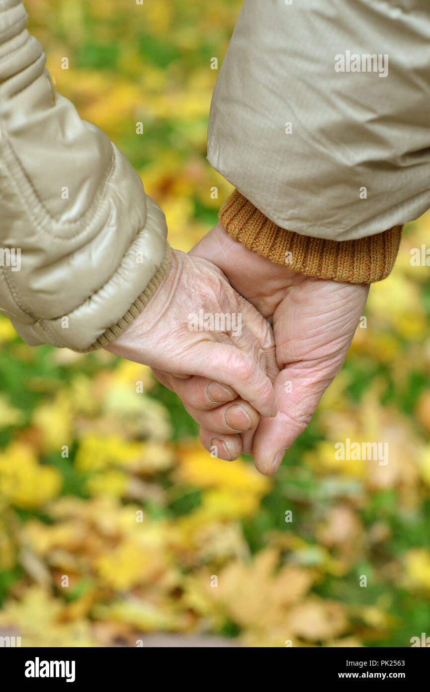 Elderly couple holding hands in hi-res stock photography and images - Alamy
