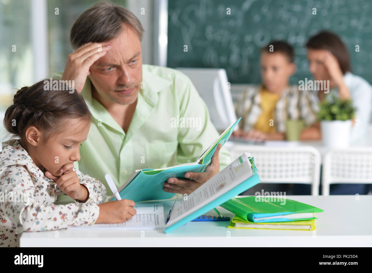 Portrait of Father helps his cute little daughter Stock Photo