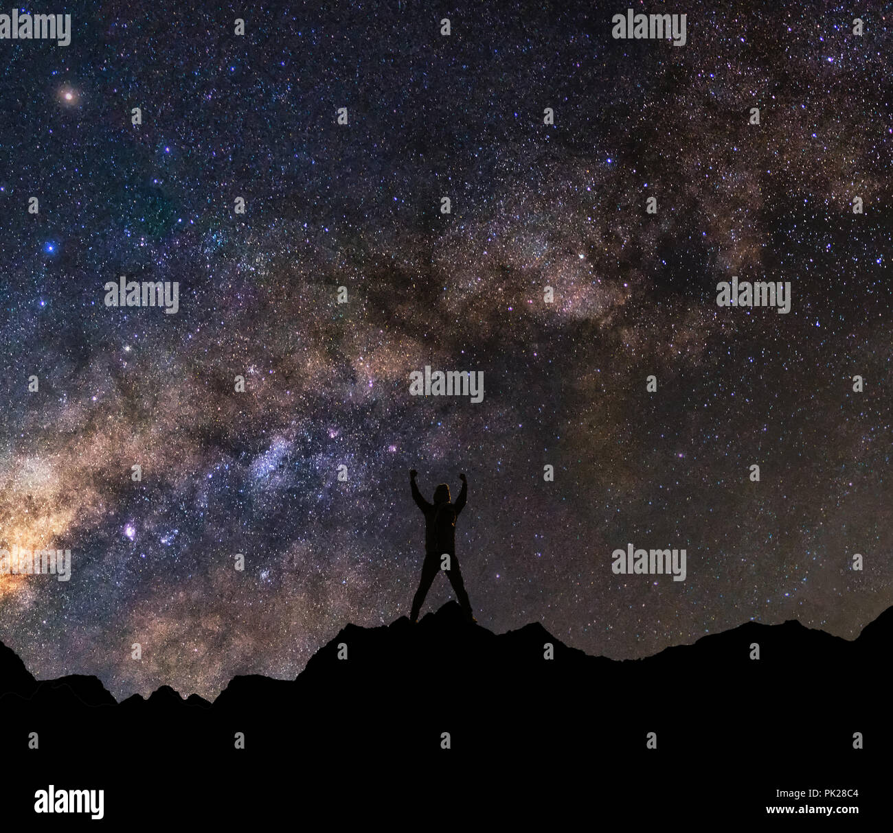 silhouette of a happy man with raised up arms to milky way background ...