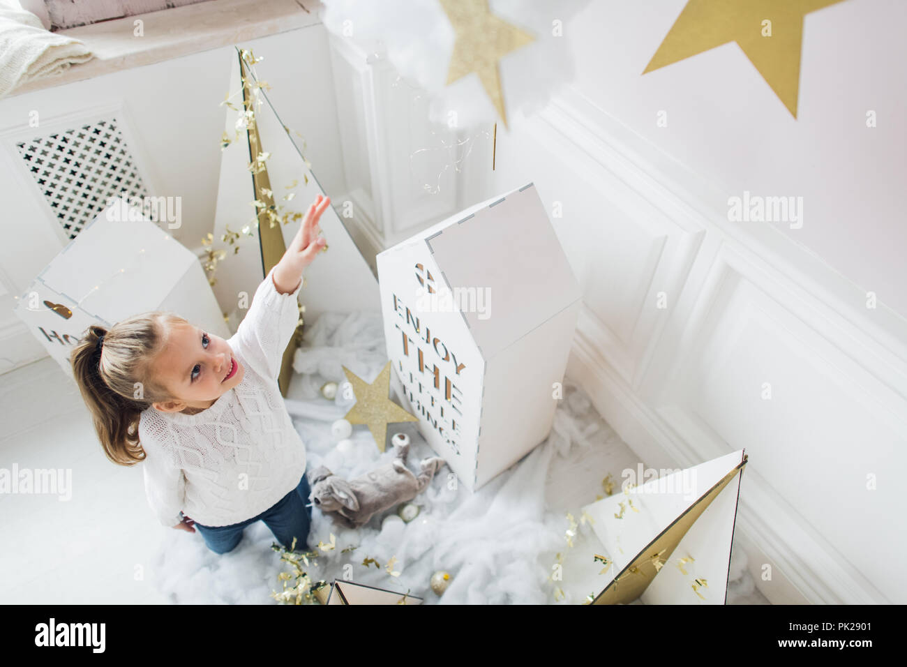 Little Girl With House Models And Stars Decoration Stock