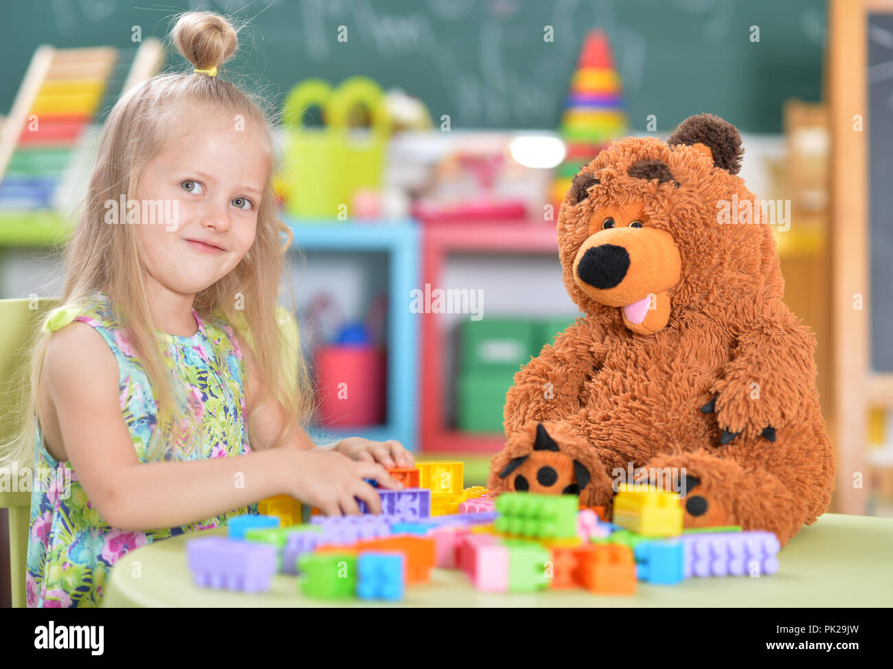 Teddy Playing Portrait of girl playing with teddy bear Stock Photo - Alamy
