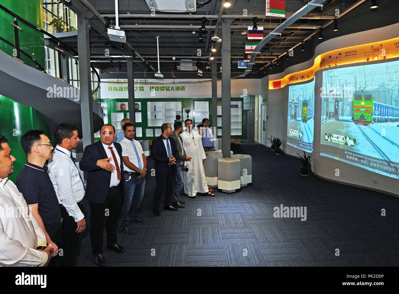 (180910) -- YIWU, Sept. 10, 2018 (Xinhua) -- Ammar introduces the benefit of China Railway Express to members of 'Silu Culture Club' in Yiwu, east China's Zhejiang Province, Sept. 7, 2018. Ammar Al- baadani, a 40-year-old Yemeni, is now a Yiwu resident, working as a doctor in Yiwu of China's Zhejiang Province. He came to China in the year of 1996 as a student and finished his bachelor's, master's degree in Tianjin Medical University and doctor's degree in Zhejiang University in China. Later he started his own business in Yiwu, and set up a non-profit organization 'Silu (Silk Road in C Stock Photo