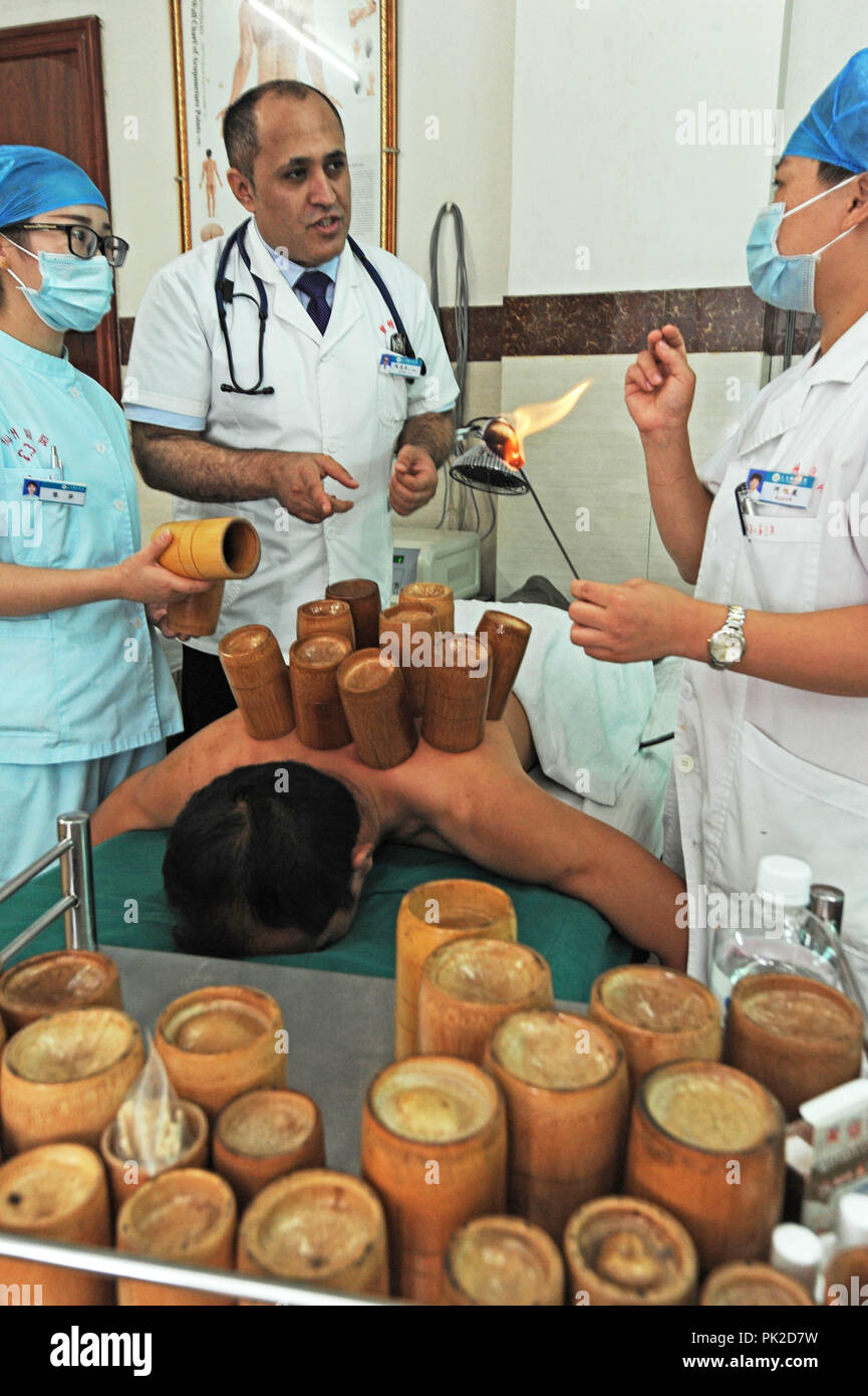 (180910) -- YIWU, Sept. 10, 2018 (Xinhua) -- Ammar learns 'Cupping Therapy' of traditional Chinese medicine in Yiwu, east China's Zhejiang Province, Sept. 5, 2018. Ammar Al- baadani, a 40-year-old Yemeni, is now a Yiwu resident, working as a doctor in Yiwu of China's Zhejiang Province. He came to China in the year of 1996 as a student and finished his bachelor's, master's degree in Tianjin Medical University and doctor's degree in Zhejiang University in China. Later he started his own business in Yiwu, and set up a non-profit organization 'Silu (Silk Road in Chinese) Culture Club' to Stock Photo